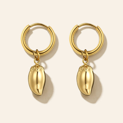 A pair of gold hoop earrings with dangling mango-shaped charms, displayed on a light beige background with soft shadows.