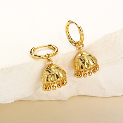 Gold hoop earrings with bell-shaped charms on a white background