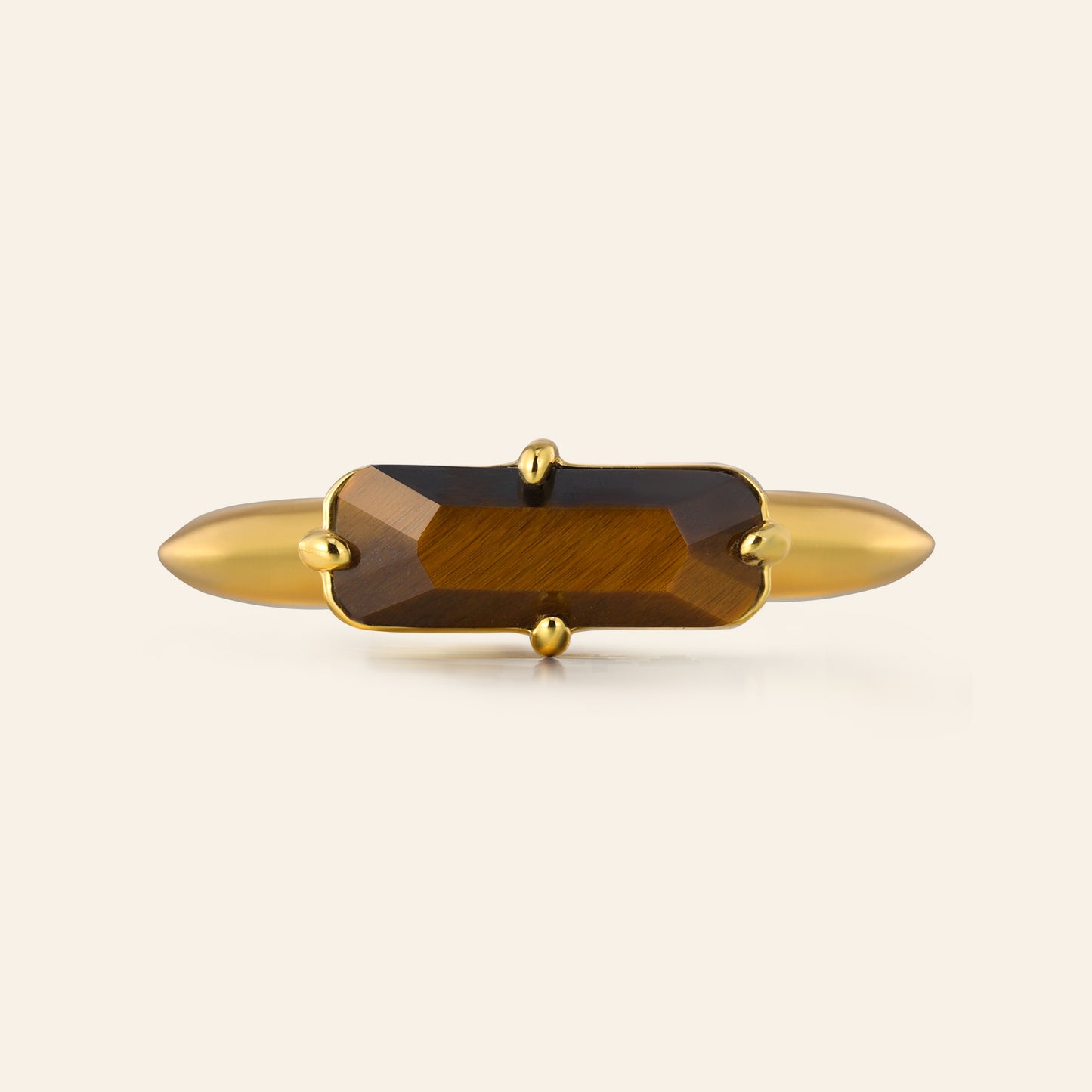 Gold with a tigers eye gemstone on a white background