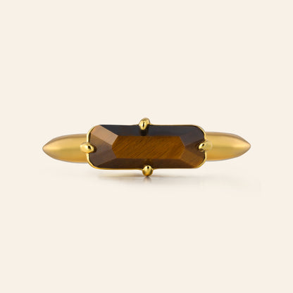 Gold with a tigers eye gemstone on a white background